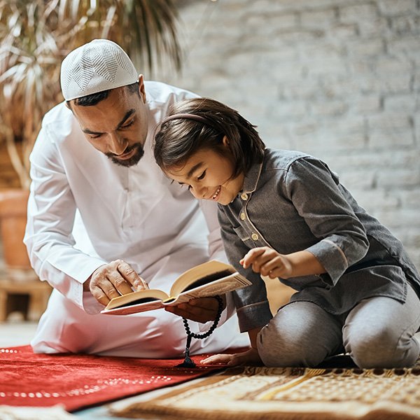 happy muslim girl and her father reading koran at D5K4CE2